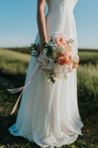 woman-wearing-white-wedding-dress-holding-flower-bouquet-1721944